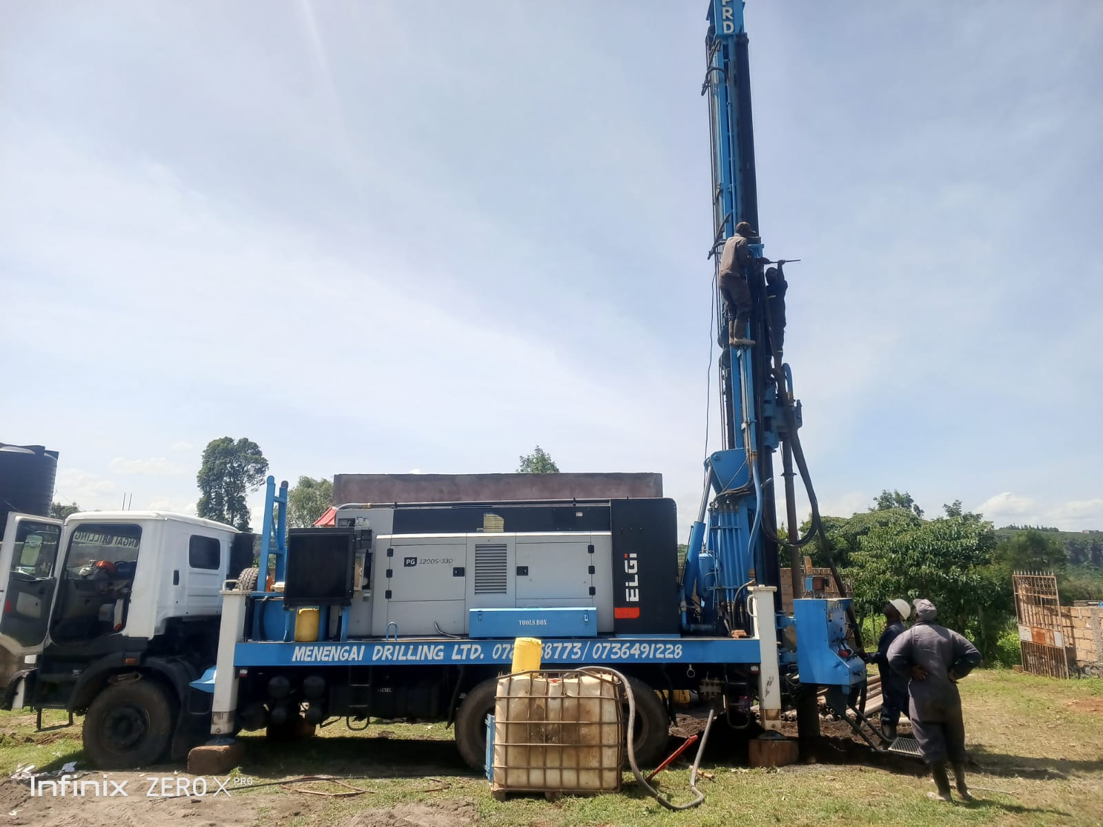 Family collecting clean drinking water from a borehole water system in Kenya